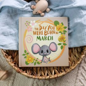 The book cover for Day You Were Born In March. A playful, illustrated mouse sat down surrounded by daffodils.